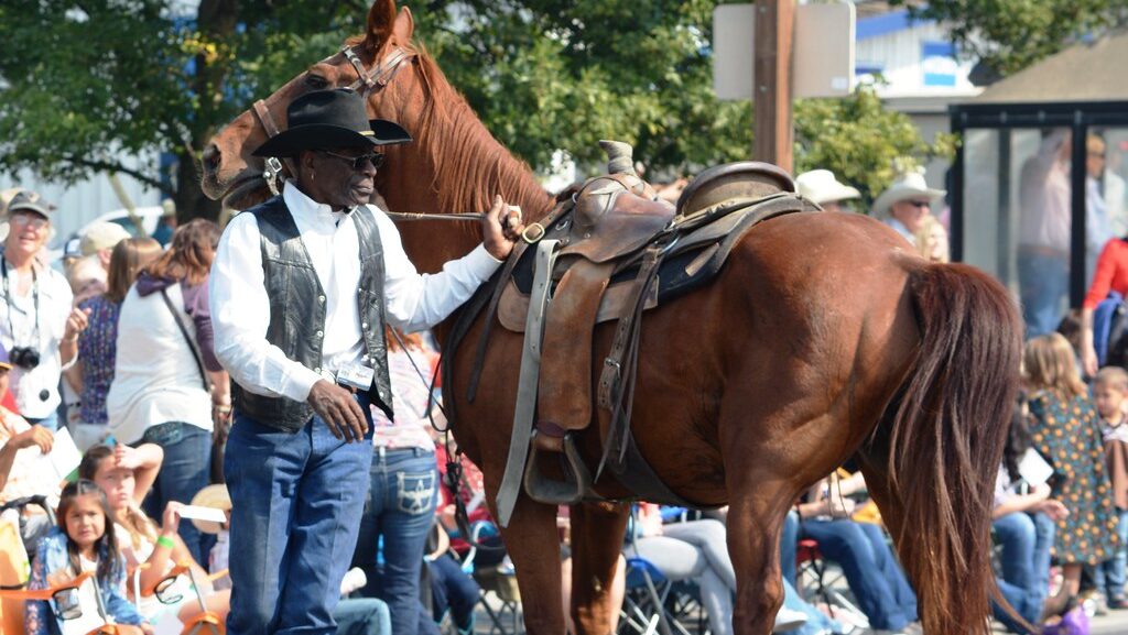 A black cowboy with horse