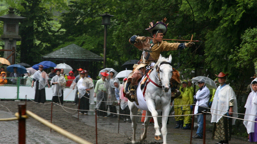 A man riding on the back of white horse