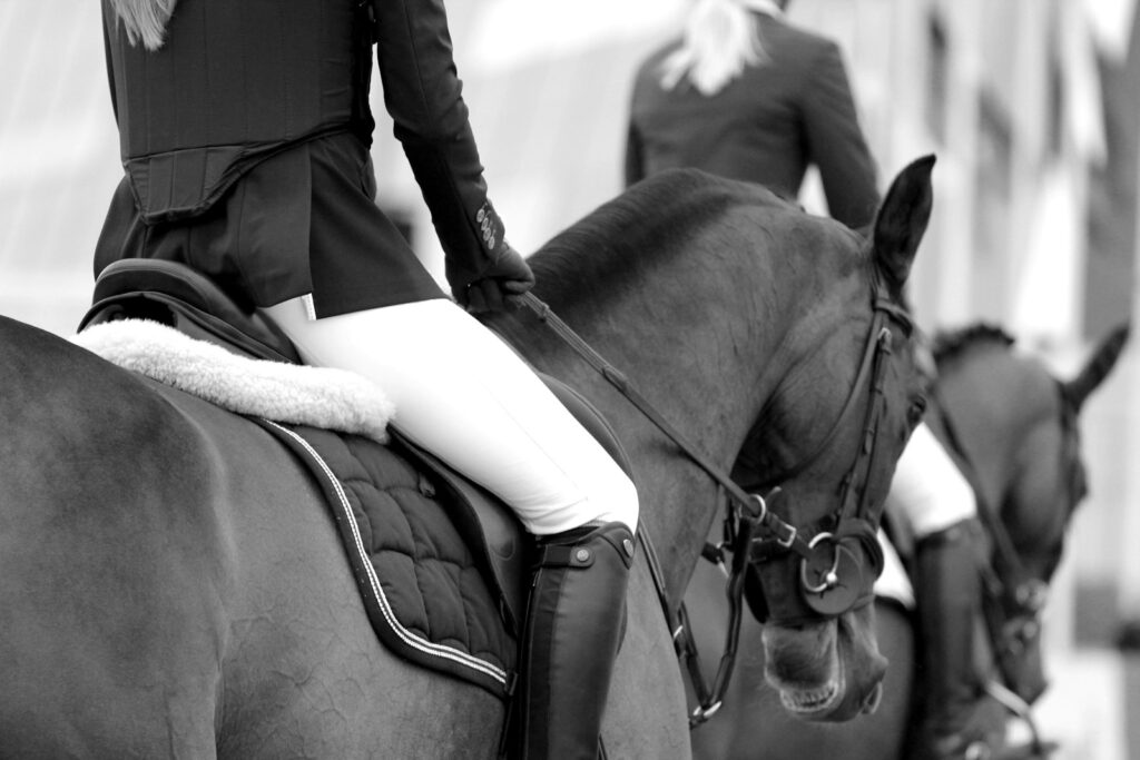 Grayscale photography of woman riding on horse