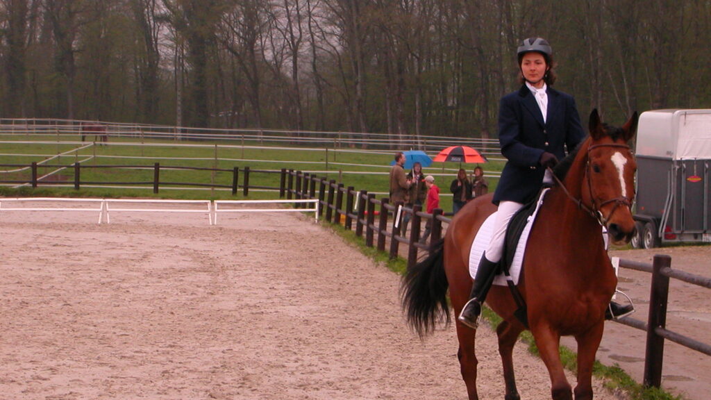 a woman riding on brown horse