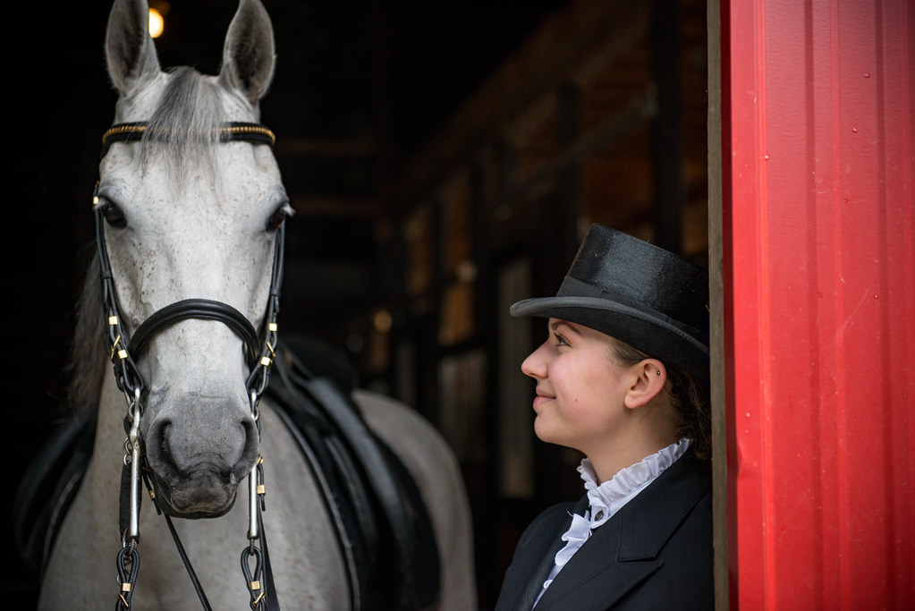 Equestrian and white horse together