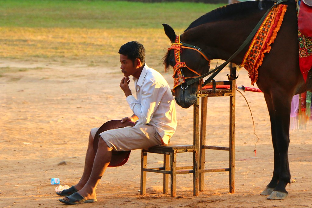 Owner thinking besides his horse