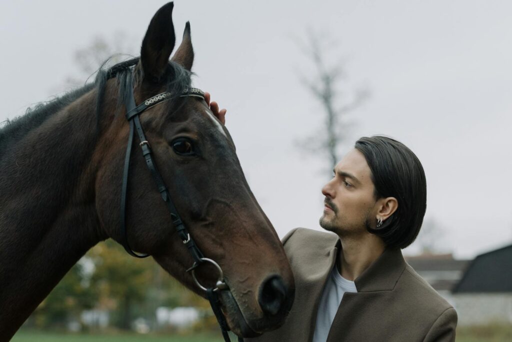 Man gently pats a horse