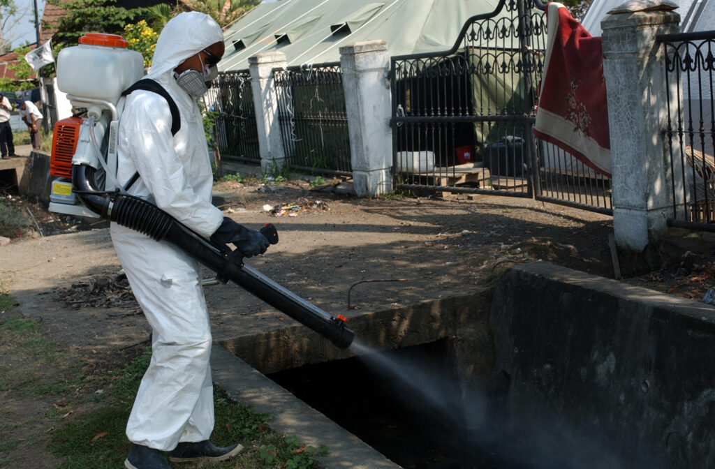 Hospital Corpsman sprays pesticides to kill flying insects known to spread disease