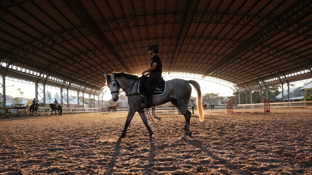 A person riding a horse inside of a building