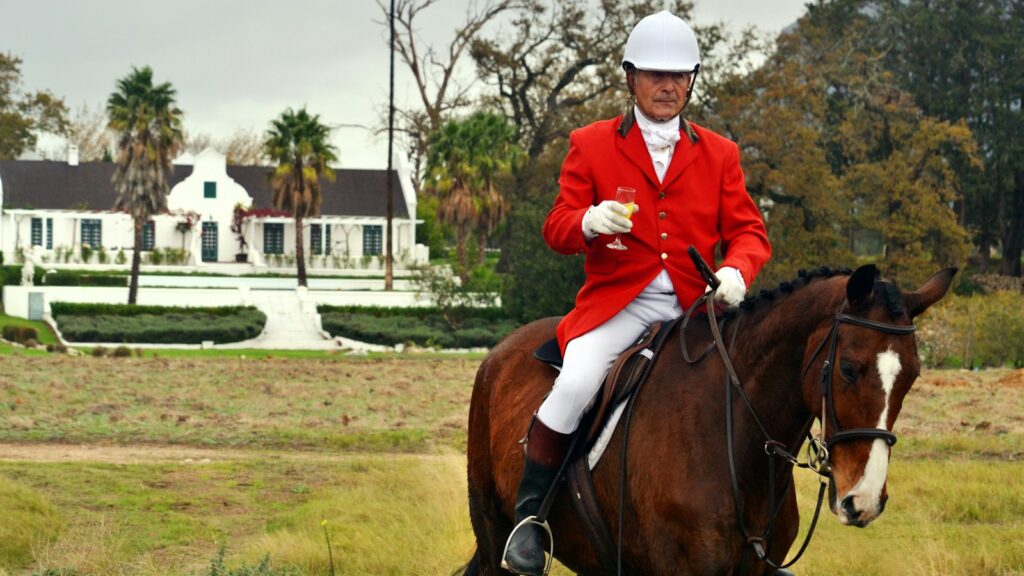 man riding horse on farm during daytime
