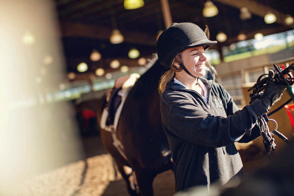 Students preparing horses for riding