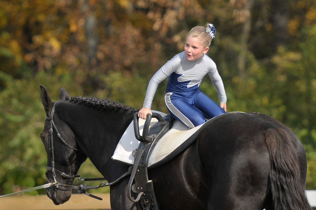 Girl vaulting in a moving horse