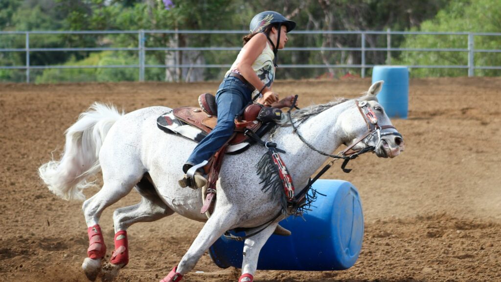 woman riding horse during daytime