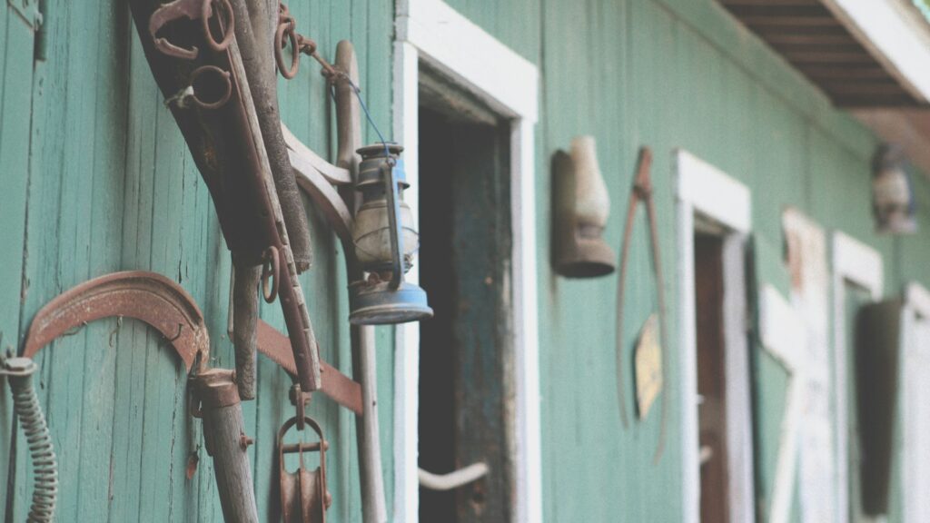 blue kerosene lamp hanged on wall rack