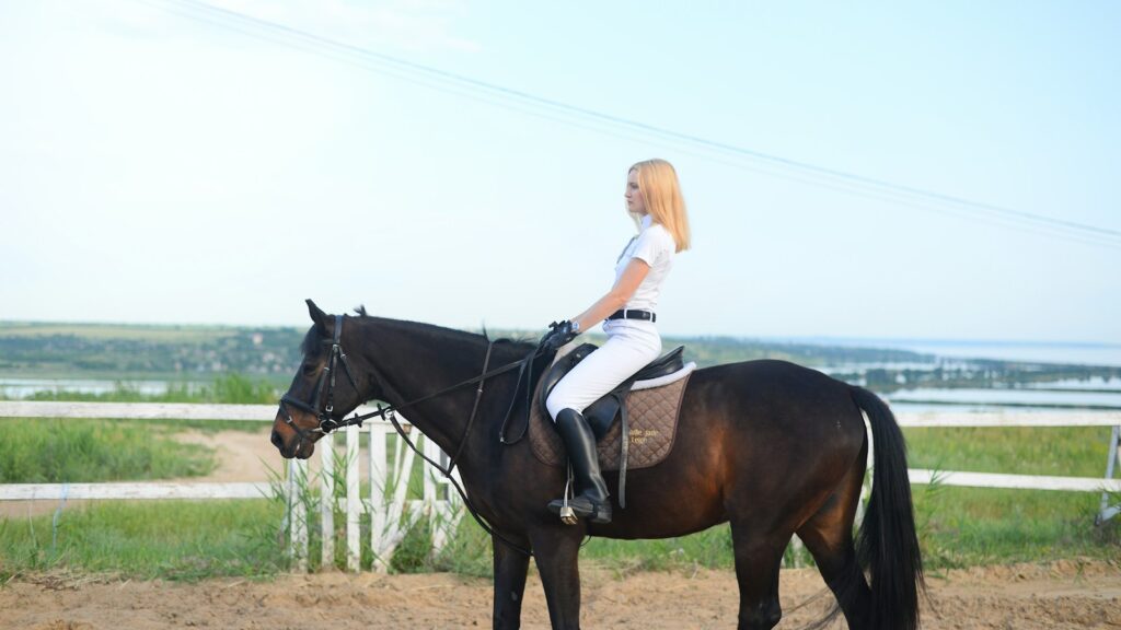 woman riding horse during daytime