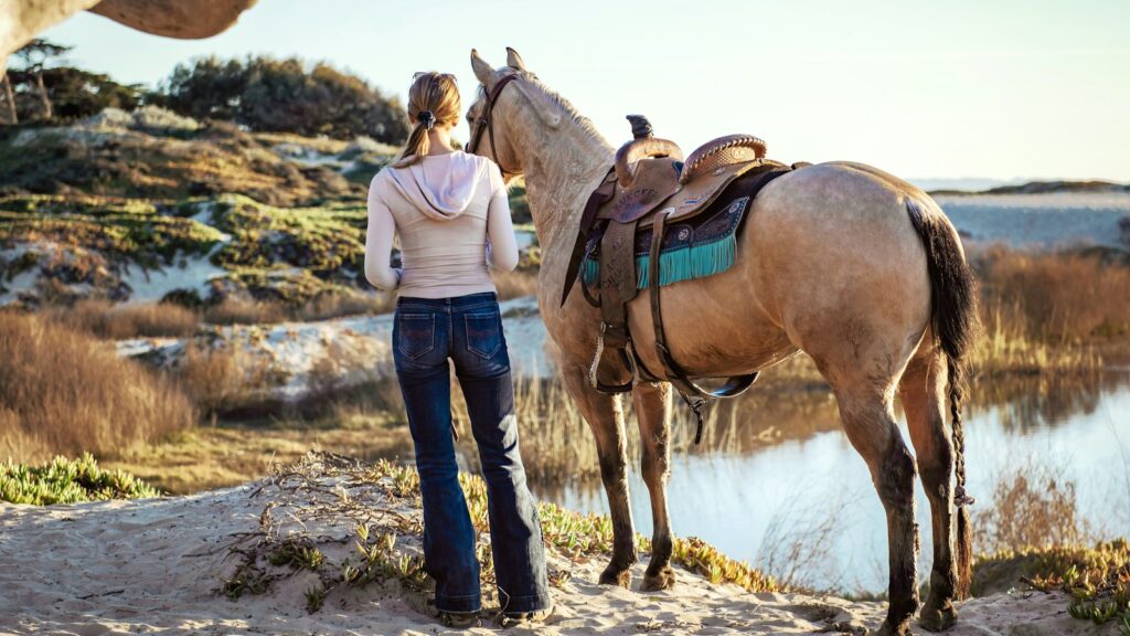 woman standing near the horse