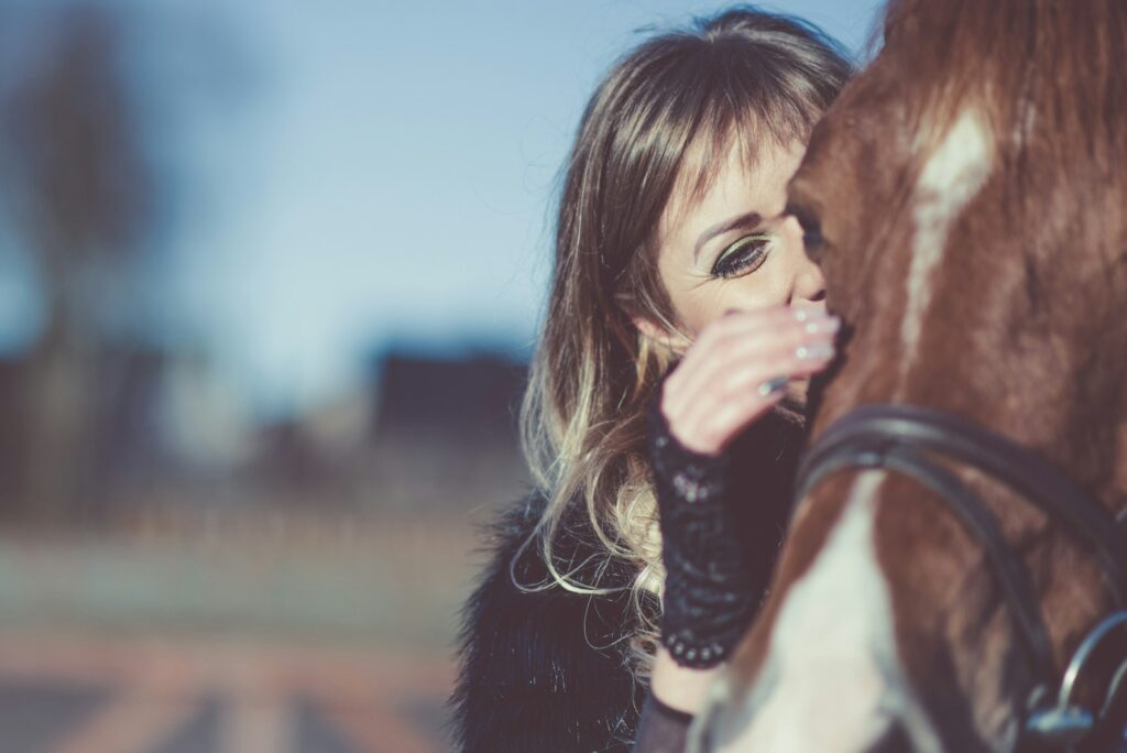 Woman petting horse