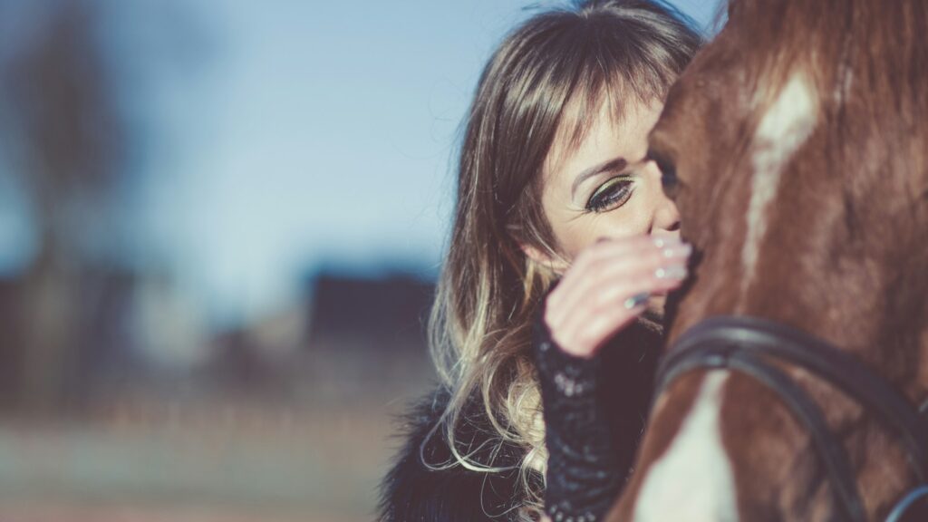 woman petting horse