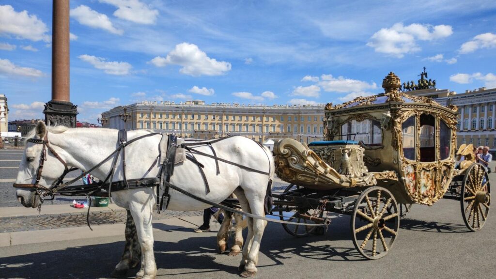 Elegant horse-drawn carriage at Palace Square in St. Petersburg on a clear day.