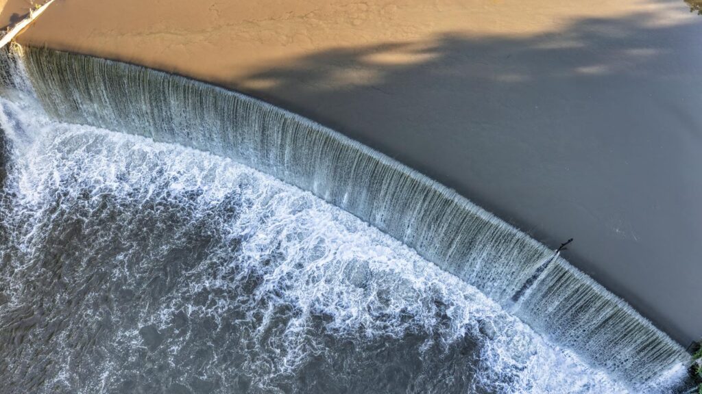 A breathtaking aerial view of the Lanesboro waterfall showcasing cascading water and a serene river.