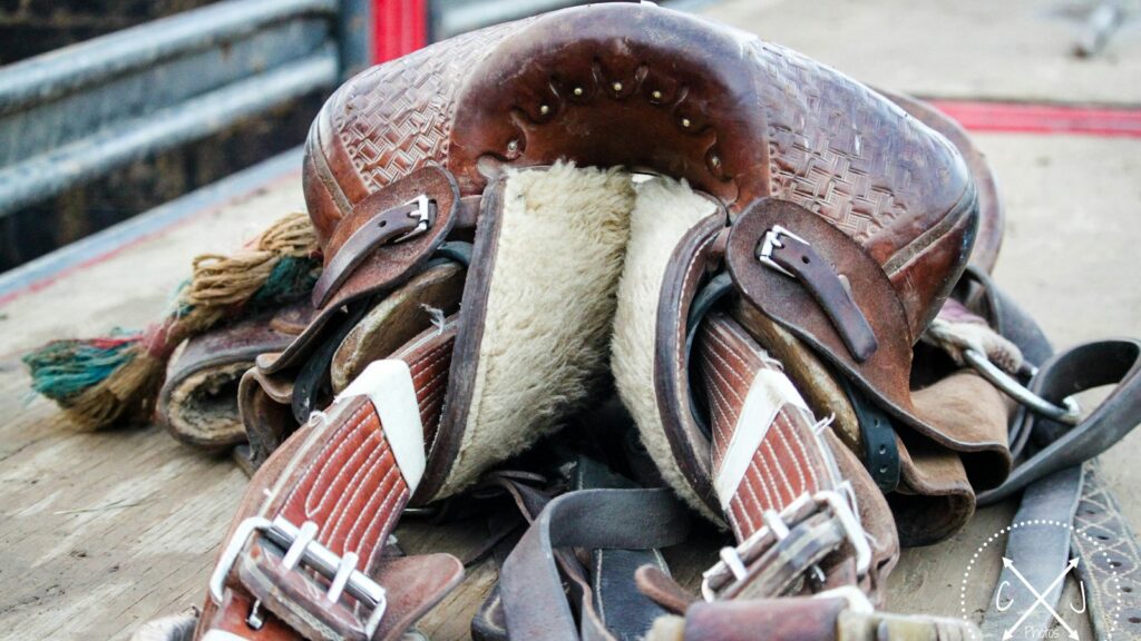 brown leather horse saddle on top of trailer