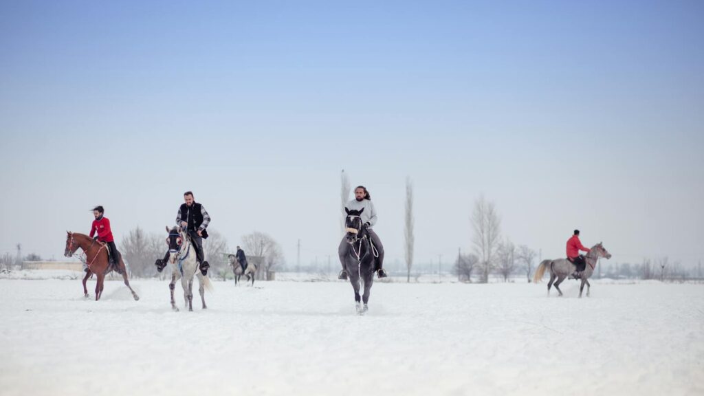 A group of riders enjoying horseback riding in snowy Erzincan, Türkiye.