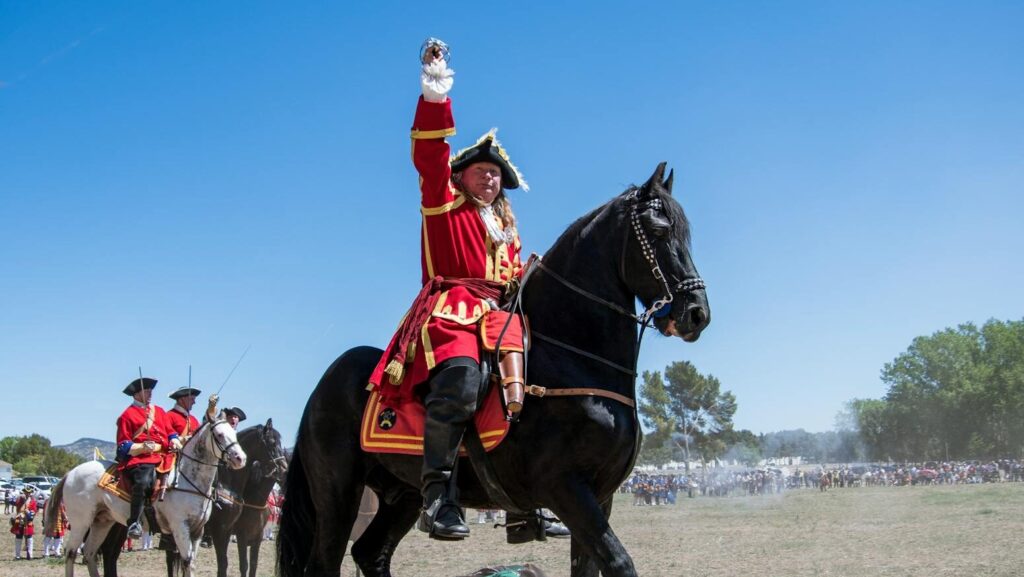 soldiers on horseback in colorful uniforms.