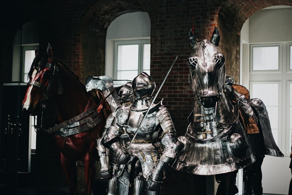 Medieval knight in full armor with a swordsman and armored horse