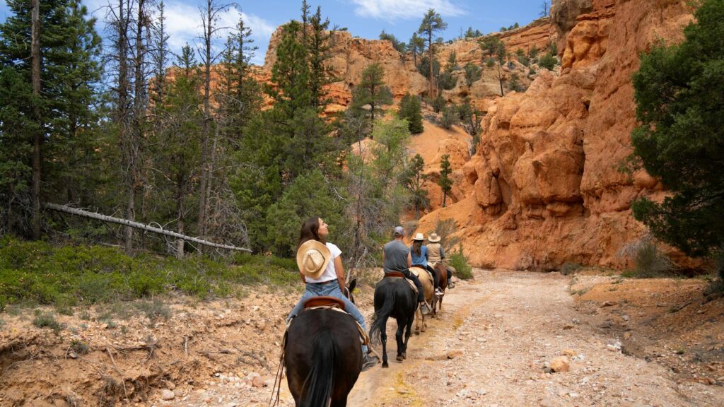 Horse riders explore the stunning natural scenery of Bryce Canyon, Utah.