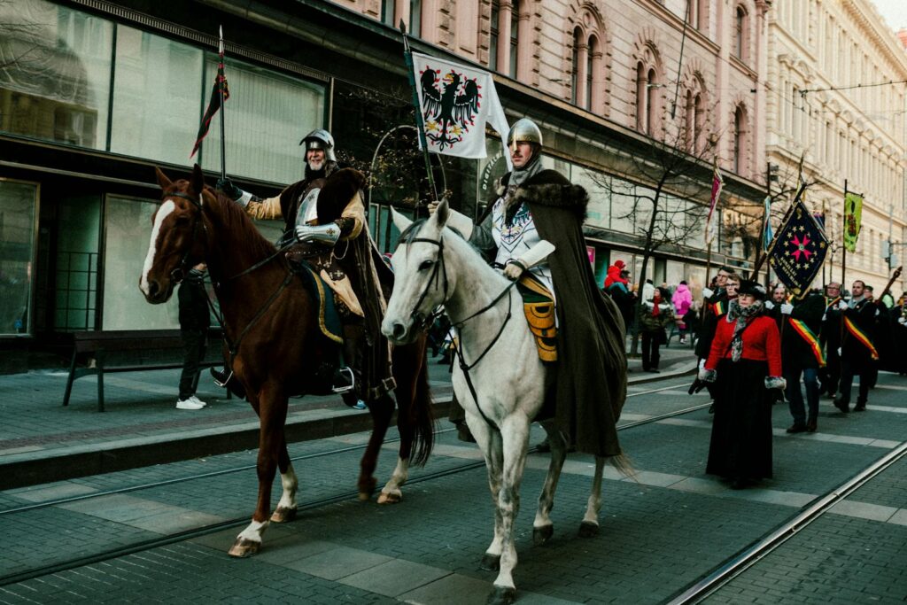 A captivating street parade featuring medieval costumed riders on horseback, attended by a joyous crowd.