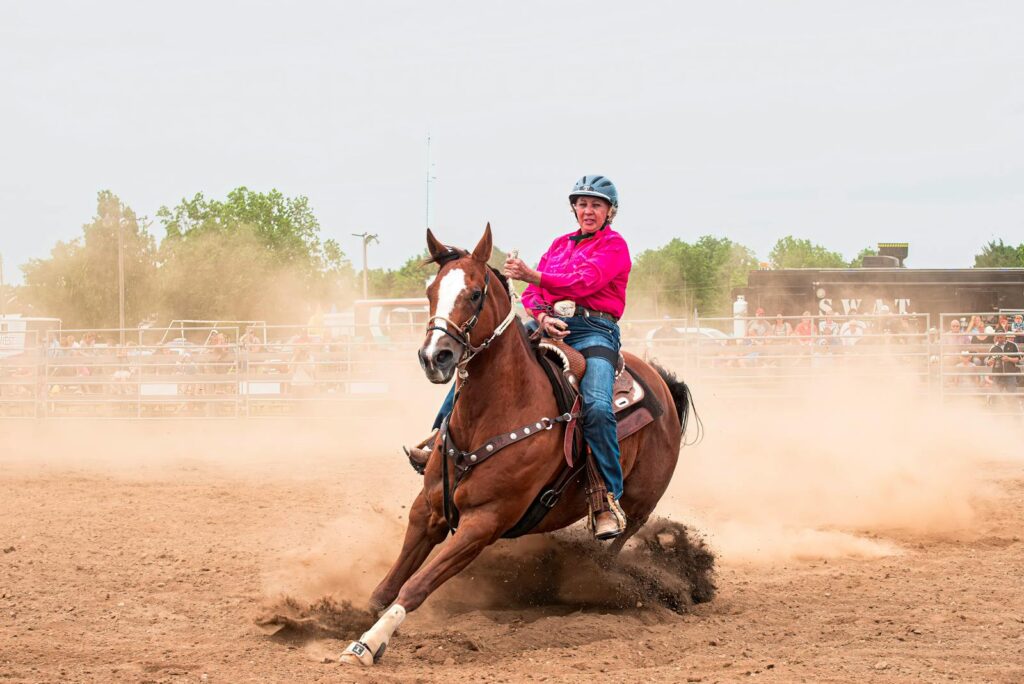 A skilled rider performing a barrel racing turn during a rodeo event.
