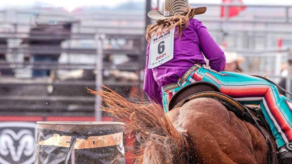 Action-packed shot of a cowboy turning a barrel during a thrilling rodeo event.