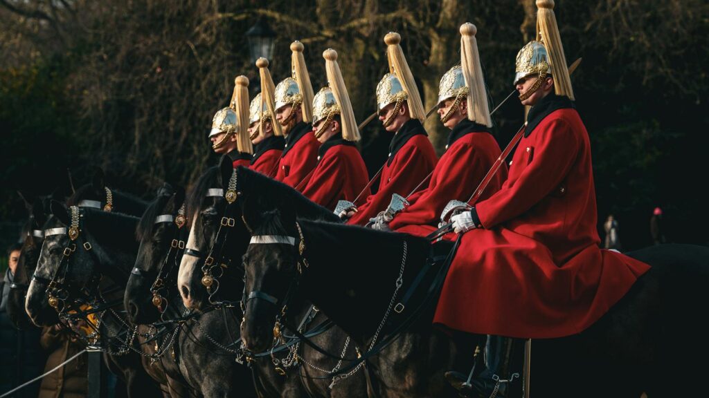 Ceremonial horse guard parade in London, England showcasing traditional British uniforms and horses.