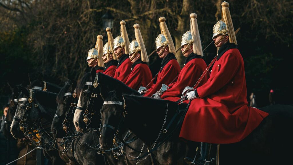 Ceremonial horse guard parade in London, England showcasing traditional British uniforms and horses.