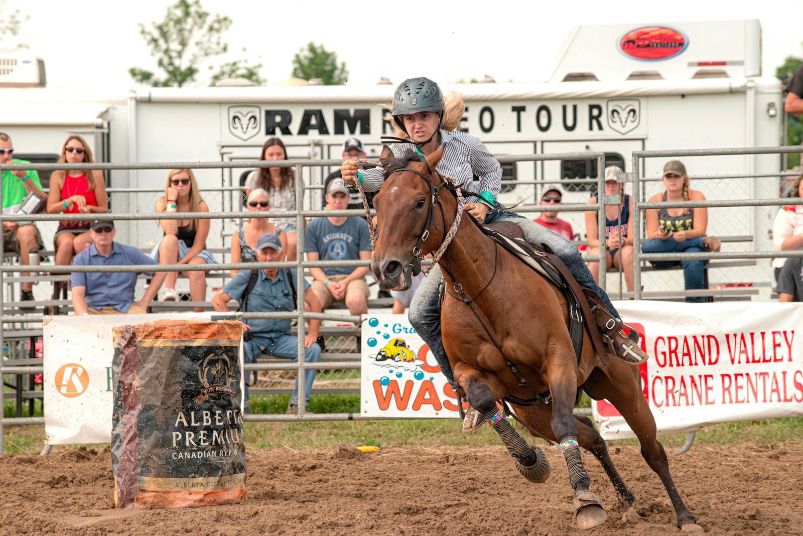 Exciting barrel racing at a rodeo event with a skilled rider and focused horse in action.