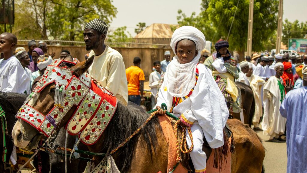 Vibrant Durbar festival in Bauchi, Nigeria featuring horsemen in colorful attire.