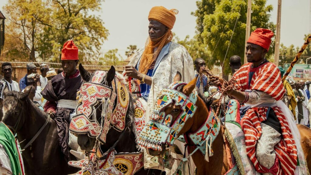 Vibrant traditional horse parade with riders in colorful attire during a cultural festival.