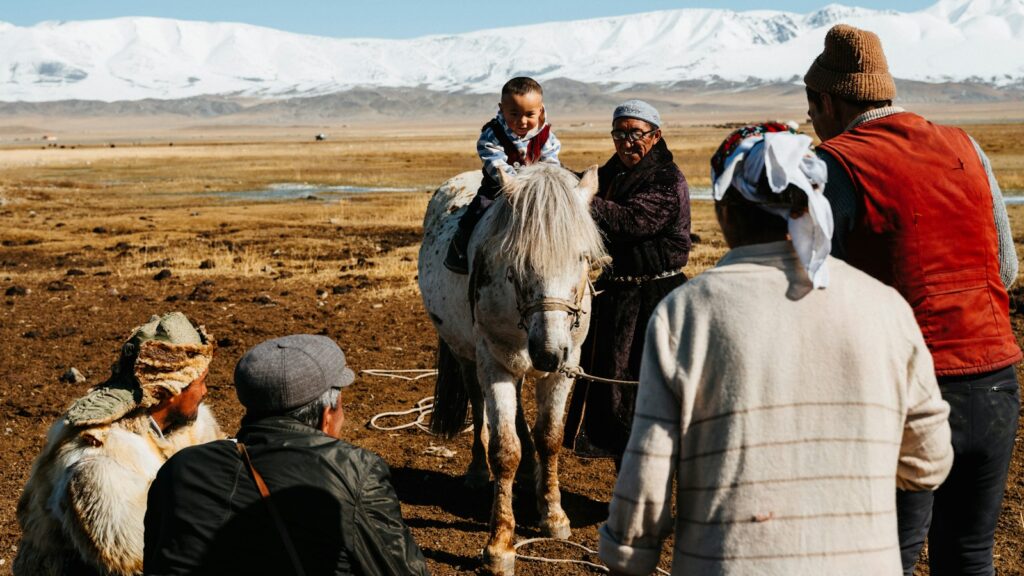 a group of people standing around a white horse