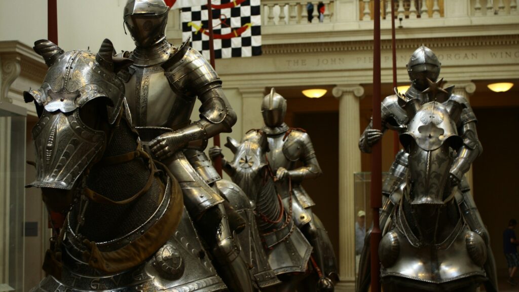 3 men in gold and black suit statue