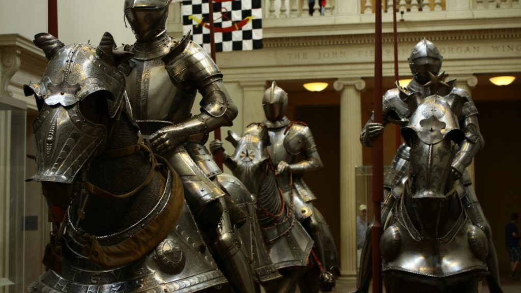 3 men in gold and black suit statue