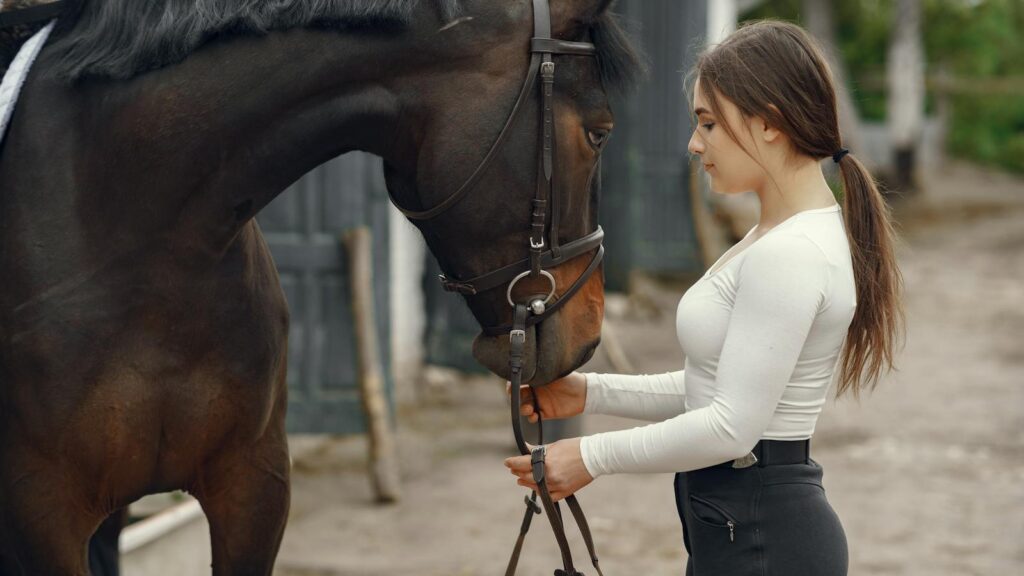 A young woman and her horse share a bonding moment outdoors, showcasing companionship.