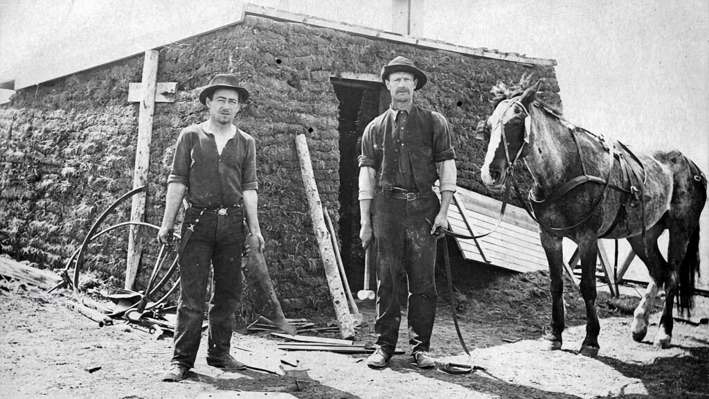 a couple of men standing next to a horse