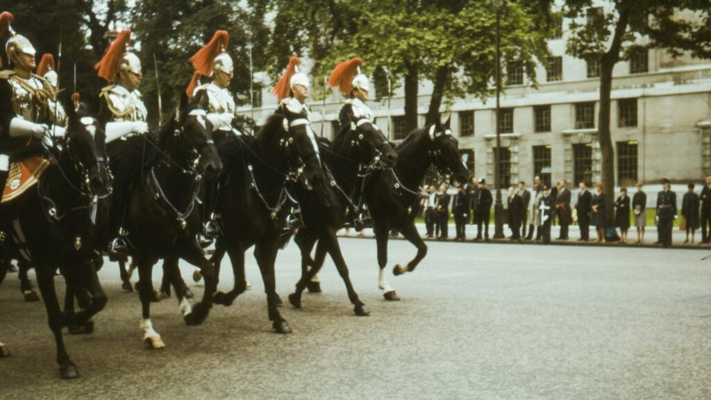 men in black and white uniform riding on black horse during daytime