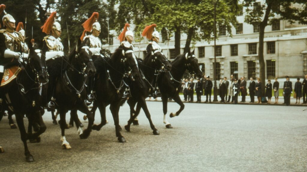 men in black and white uniform riding on black horse during daytime