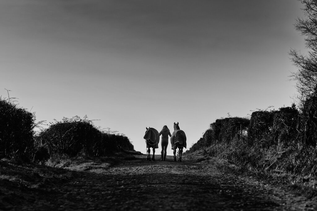 Grayscale photo of people walking on the road
