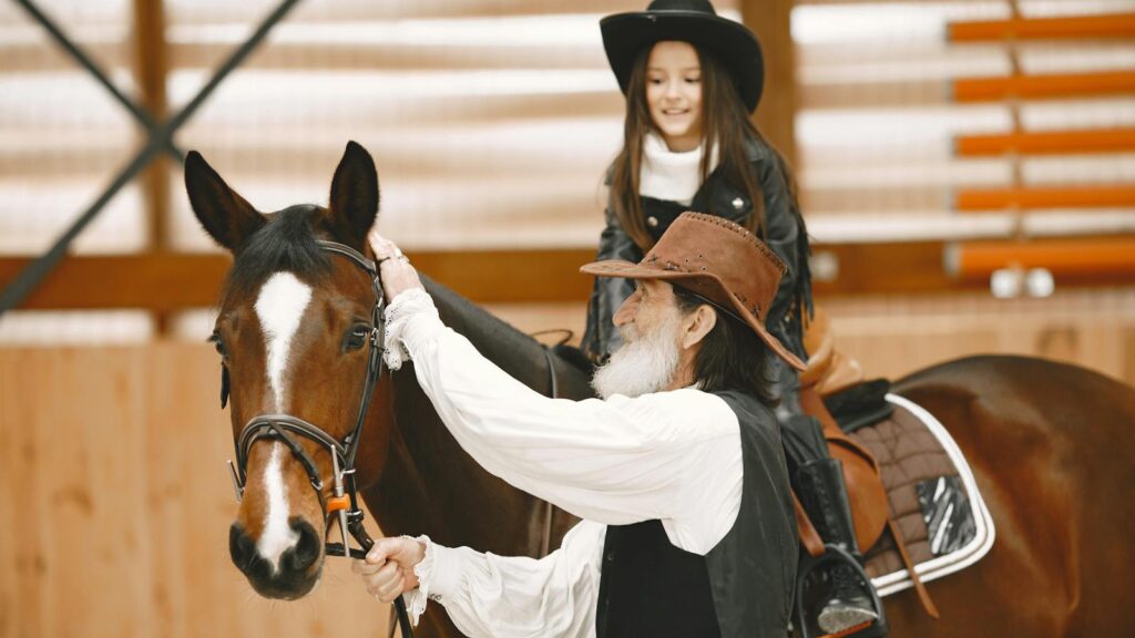 a man stading wuth brown horse