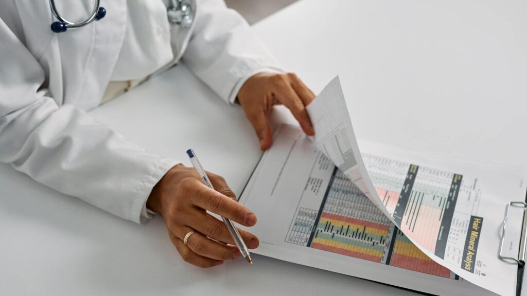 A medical professional checking patient reports with a clipboard in an office setting.