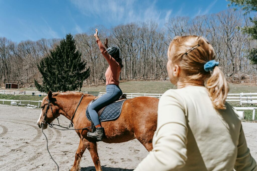 Woman learning horseback riding with an instructor