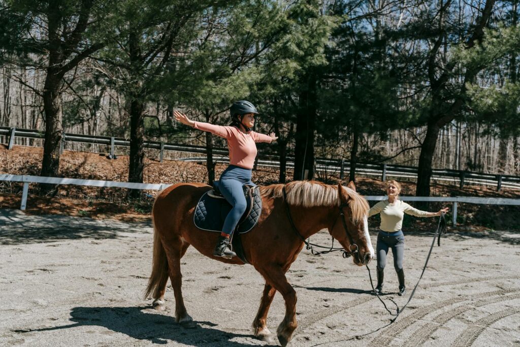 Woman practices riding techniques in a park setting, emphasizing balance and skill development.