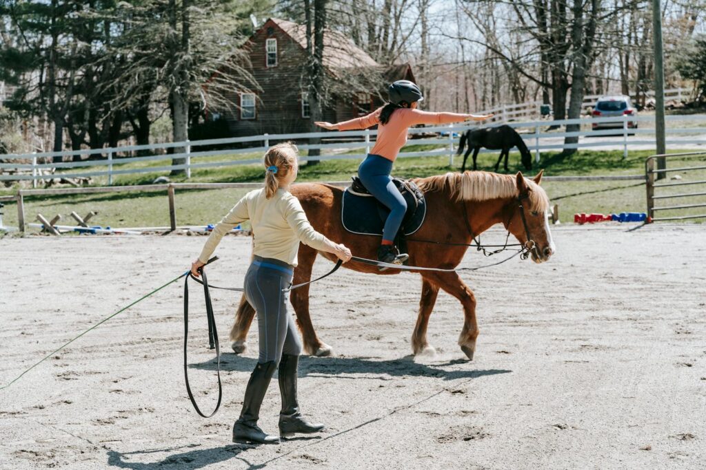 Young student learns horseback riding under the guidance of an instructor