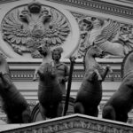 Elaborate horse sculptures and ornate relief on a historical building facade