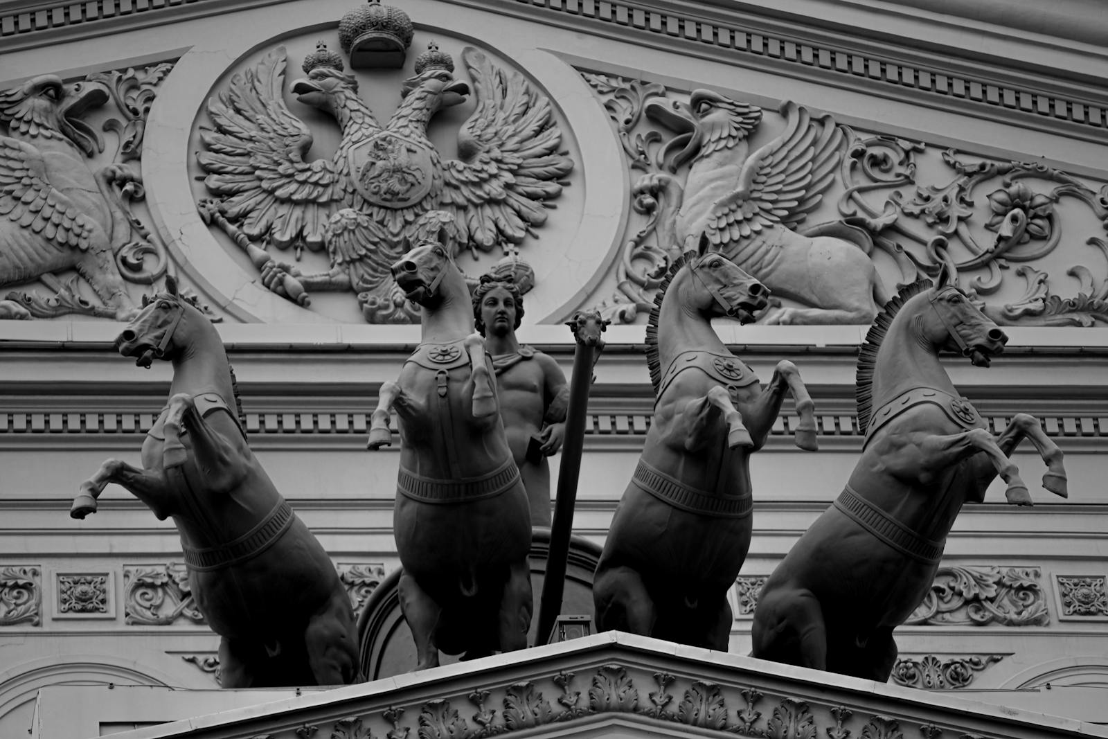 Elaborate horse sculptures and ornate relief on a historical building facade