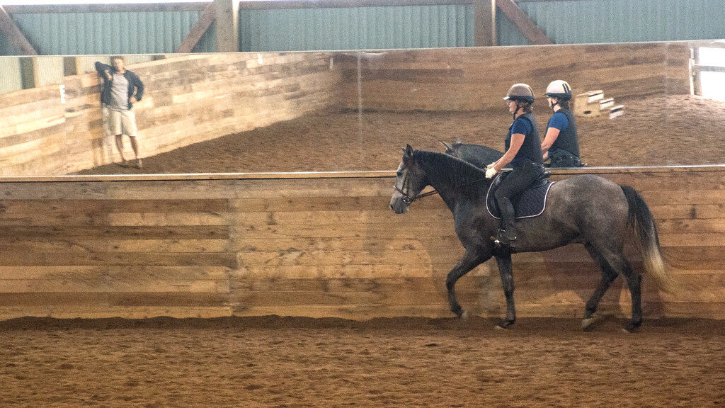 two men riding horses