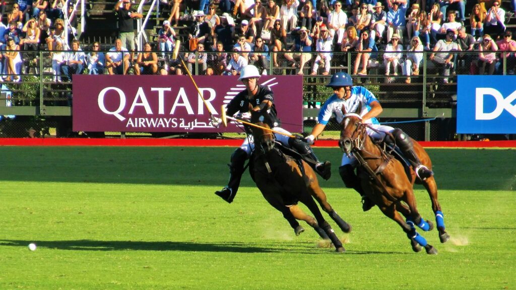 two person riding horse during daytime